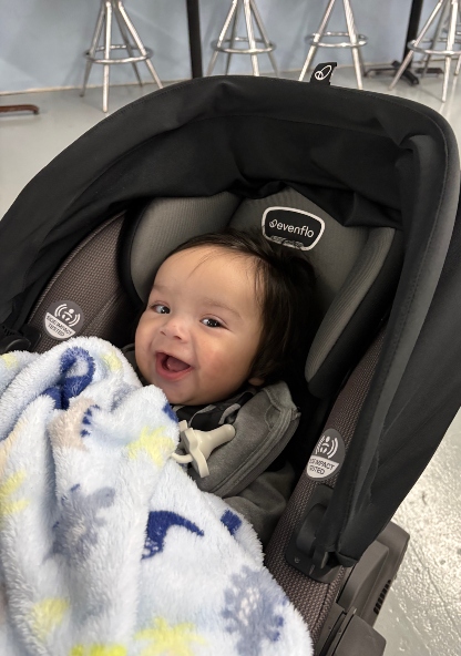 Casen smiling in his car seat. Casen is doing great after receiving care at CHRISTUS Children's