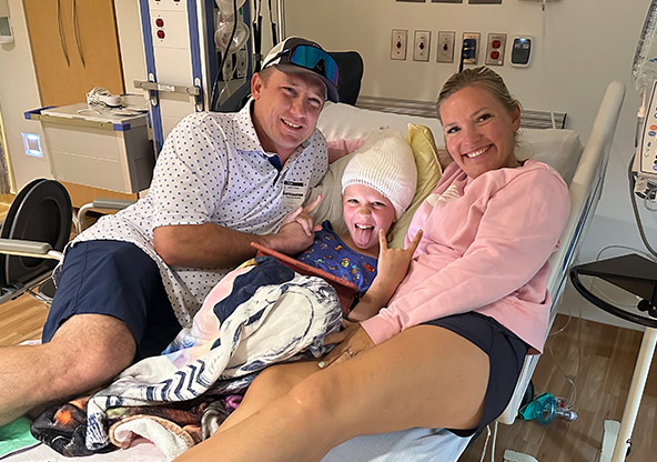 Maisyn and her parents in her hospital bed after a procedure at CHRISTUS Children's