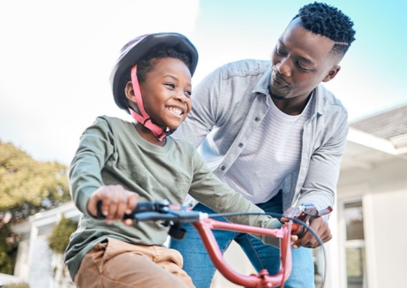 A father teaching his son how to ride a bike